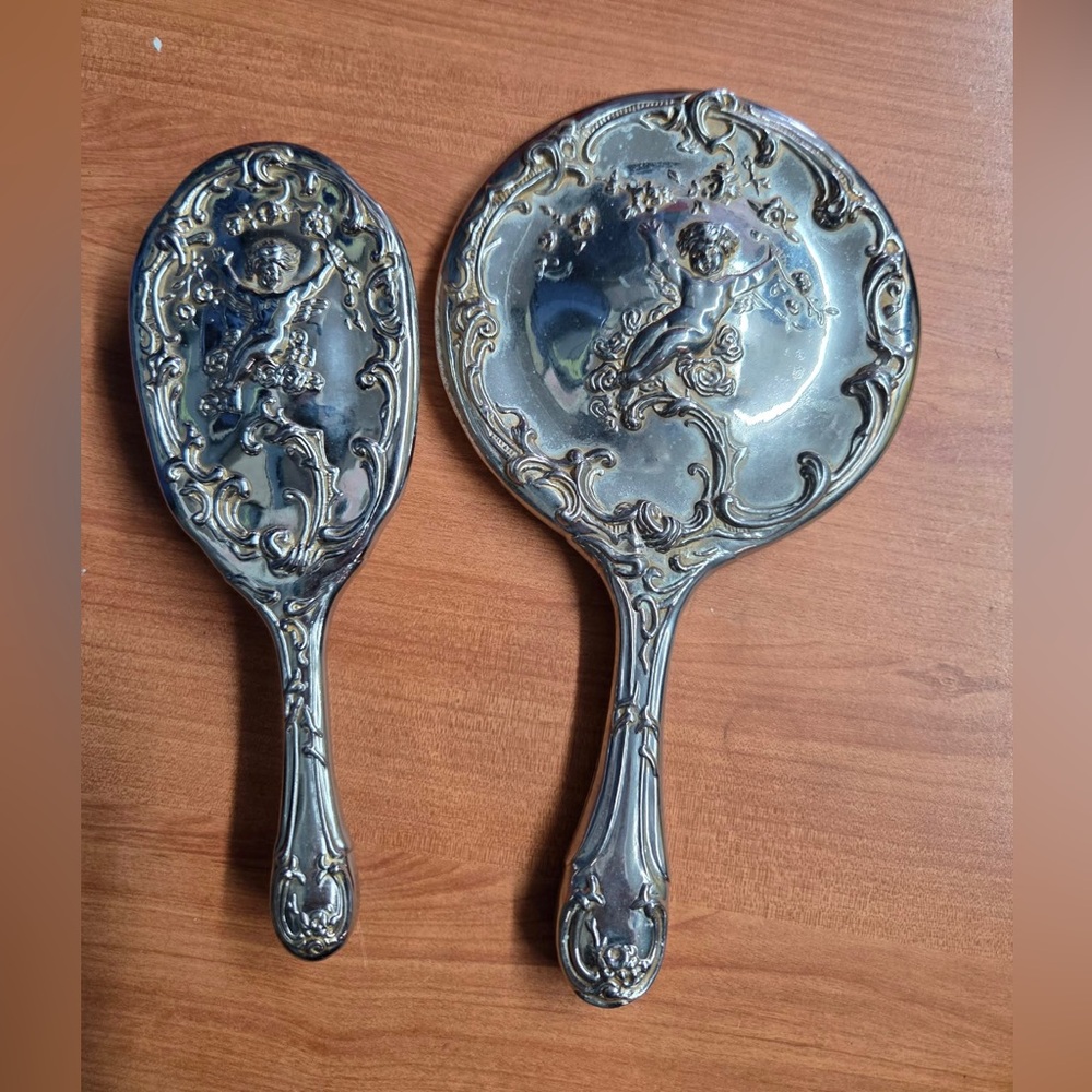 vintage Art Nouveau cherub-themed vanity mirror and brush set